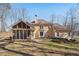 House back exterior with a screened porch and patio area at 4035 Powerscourt Pl, Suwanee, GA 30024