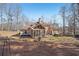 House back exterior showcasing a screened porch and backyard at 4035 Powerscourt Pl, Suwanee, GA 30024