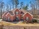 Brick house with two-car garage and landscaped yard at 4035 Powerscourt Pl, Suwanee, GA 30024