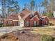 Brick house with two-car garage and landscaped yard at 4035 Powerscourt Pl, Suwanee, GA 30024