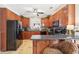 Well-equipped kitchen featuring wood cabinets, granite countertops, and black appliances at 4035 Powerscourt Pl, Suwanee, GA 30024