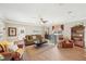 Comfortable living room with hardwood floors, a ceiling fan, and built-in shelving at 4035 Powerscourt Pl, Suwanee, GA 30024