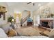 Open living area showcasing hardwood floors, a staircase, and a cozy fireplace at 4035 Powerscourt Pl, Suwanee, GA 30024