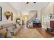 Open living area showcasing hardwood floors, a staircase, and a cozy fireplace at 4035 Powerscourt Pl, Suwanee, GA 30024