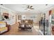 Comfortable living room with hardwood floors, a ceiling fan, and built-in shelving at 4035 Powerscourt Pl, Suwanee, GA 30024