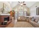 Bright living room featuring hardwood floors, a fireplace, and ample natural light at 4035 Powerscourt Pl, Suwanee, GA 30024