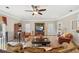 Comfortable living room with hardwood floors, a ceiling fan, and built-in shelving at 4035 Powerscourt Pl, Suwanee, GA 30024