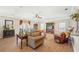 Comfortable living room with hardwood floors, a ceiling fan, and built-in shelving at 4035 Powerscourt Pl, Suwanee, GA 30024