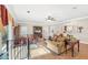 Comfortable living room with hardwood floors, a ceiling fan, and built-in shelving at 4035 Powerscourt Pl, Suwanee, GA 30024