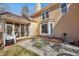 Concrete patio with seating area adjacent to the house at 4035 Powerscourt Pl, Suwanee, GA 30024