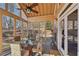 Bright screened porch featuring a ceiling fan and wooded views at 4035 Powerscourt Pl, Suwanee, GA 30024