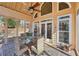 Relaxing screened porch with glass top table and wicker chairs at 4035 Powerscourt Pl, Suwanee, GA 30024