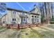 Home exterior featuring a spacious wooden deck and a backyard with mature trees at 976 Forest Pond Cir, Marietta, GA 30068