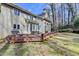 Home exterior featuring a spacious wooden deck and a backyard with mature trees at 976 Forest Pond Cir, Marietta, GA 30068