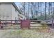 Exterior view of a home's fenced backyard showing the patio and surrounding trees at 976 Forest Pond Cir, Marietta, GA 30068