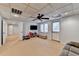 Finished basement with neutral carpet, a ceiling fan, shelving for toys, and an exterior door at 976 Forest Pond Cir, Marietta, GA 30068