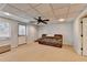 Finished basement featuring neutral carpet, a ceiling fan, and a comfortable sofa at 976 Forest Pond Cir, Marietta, GA 30068