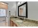 Bathroom vanity featuring granite countertop, dark hardware, and decorative mirror at 976 Forest Pond Cir, Marietta, GA 30068