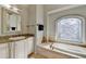 Bright bathroom featuring a soaking tub, tile detail, granite countertop, and vanity at 976 Forest Pond Cir, Marietta, GA 30068