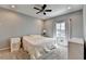 Bedroom with neutral walls, ceiling fan, carpeted floor, and window with curtains at 976 Forest Pond Cir, Marietta, GA 30068