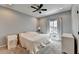 Bedroom with soft gray walls, plush carpet, a ceiling fan, and natural light from the windows at 976 Forest Pond Cir, Marietta, GA 30068