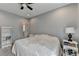 Bedroom with neutral walls, carpeted floor, white bookcase, and window with curtains at 976 Forest Pond Cir, Marietta, GA 30068