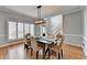 Traditional dining room leads to the foyer with staircase and has lots of light from the large window at 976 Forest Pond Cir, Marietta, GA 30068