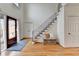 Bright foyer with hardwood floors, staircase, and a stylish front door at 976 Forest Pond Cir, Marietta, GA 30068