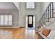 Bright foyer with hardwood floors, staircase, and modern accents at 976 Forest Pond Cir, Marietta, GA 30068