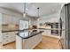 Traditional kitchen with white cabinets, island with black countertop, stainless steel appliances and pendant lights at 976 Forest Pond Cir, Marietta, GA 30068