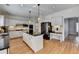 Traditional kitchen with island, white cabinets, black countertops, stainless steel appliances and hardwood floors at 976 Forest Pond Cir, Marietta, GA 30068