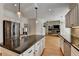 Traditional kitchen with island and breakfast bar, white cabinets, black countertops, stainless appliances and open floor plan at 976 Forest Pond Cir, Marietta, GA 30068