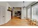 Bright living room with hardwood floors, modern light fixture, and view of fireplace at 976 Forest Pond Cir, Marietta, GA 30068