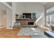 Beautiful living room with stone fireplace, built-in seating, and large windows at 976 Forest Pond Cir, Marietta, GA 30068