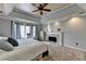 Spacious main bedroom featuring fireplace, tray ceiling, and large windows at 976 Forest Pond Cir, Marietta, GA 30068