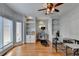 Spacious home office boasts custom built-ins, hardwood flooring, natural light, and dedicated treadmill area at 976 Forest Pond Cir, Marietta, GA 30068