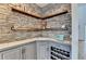 Unique wet bar featuring stone accent wall, floating wood shelves, and tile countertops at 976 Forest Pond Cir, Marietta, GA 30068