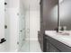 Clean bathroom featuring a glass shower, white subway tile, and stylish gray cabinetry for a modern feel at 1371 Walking Way, Atlanta, GA 30316