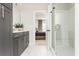 Elegant bathroom showcasing a glass shower, stylish vanity, and a view into the serene main bedroom at 1371 Walking Way, Atlanta, GA 30316