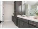 Modern bathroom with stylish grey cabinets, double sinks, and a glass-enclosed shower for a spa-like feel at 1371 Walking Way, Atlanta, GA 30316