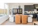 Dining room features a modern light fixture, a stylish display cabinet, and an adjacent view of the kitchen at 1371 Walking Way, Atlanta, GA 30316