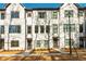 Modern townhome with a white brick facade, dark framed windows, and professional landscaping at 1371 Walking Way, Atlanta, GA 30316