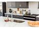 Close-up of the kitchen sink and countertop with modern fixtures and stylish backsplash at 1371 Walking Way, Atlanta, GA 30316