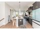 Bright kitchen featuring a large island with barstool seating, sleek cabinetry, and modern stainless steel appliances at 1371 Walking Way, Atlanta, GA 30316