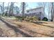 Backyard view of the multi-story home with brick and siding exterior, deck, and lawn at 2265 Pine Point Dr, Lawrenceville, GA 30043