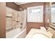 Bathroom featuring a shower-tub combination, neutral stone-look tiling, and modern vanity at 2265 Pine Point Dr, Lawrenceville, GA 30043