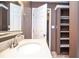 Bathroom featuring a modern sink with a chrome faucet and a built-in wall shelving unit at 2265 Pine Point Dr, Lawrenceville, GA 30043