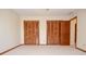 Bedroom featuring 2 large closets with bi-fold doors and neutral carpet at 2265 Pine Point Dr, Lawrenceville, GA 30043