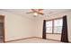 Bedroom featuring a ceiling fan, neutral carpet, and windows with curtains at 2265 Pine Point Dr, Lawrenceville, GA 30043