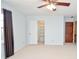 Bedroom with a large closet, neutral carpet, and an ceiling fan at 2265 Pine Point Dr, Lawrenceville, GA 30043